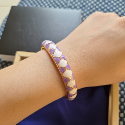 Decorative Bangle with purple and white pattern on a textured surface
